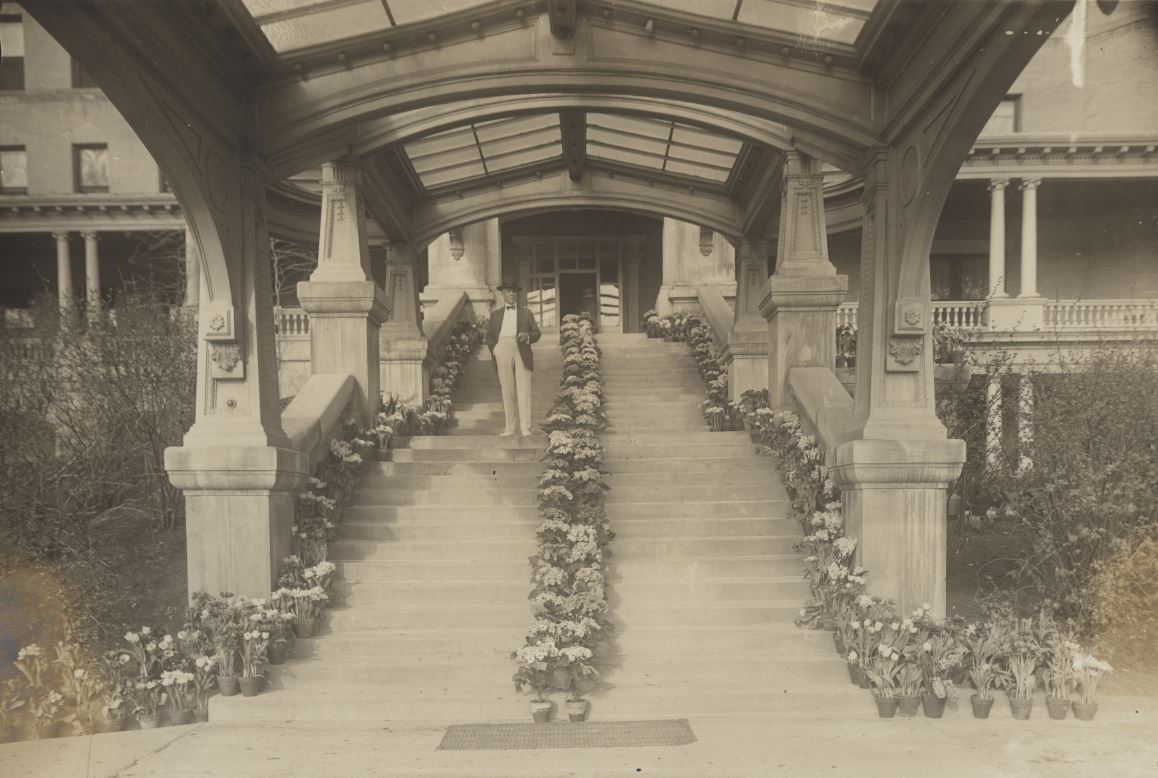 a man standing on a staircase with flowers on it