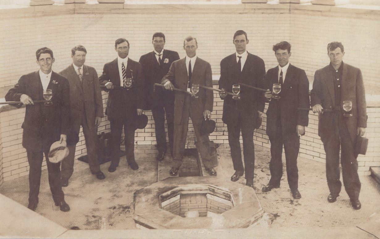 a group of men holding wine glasses