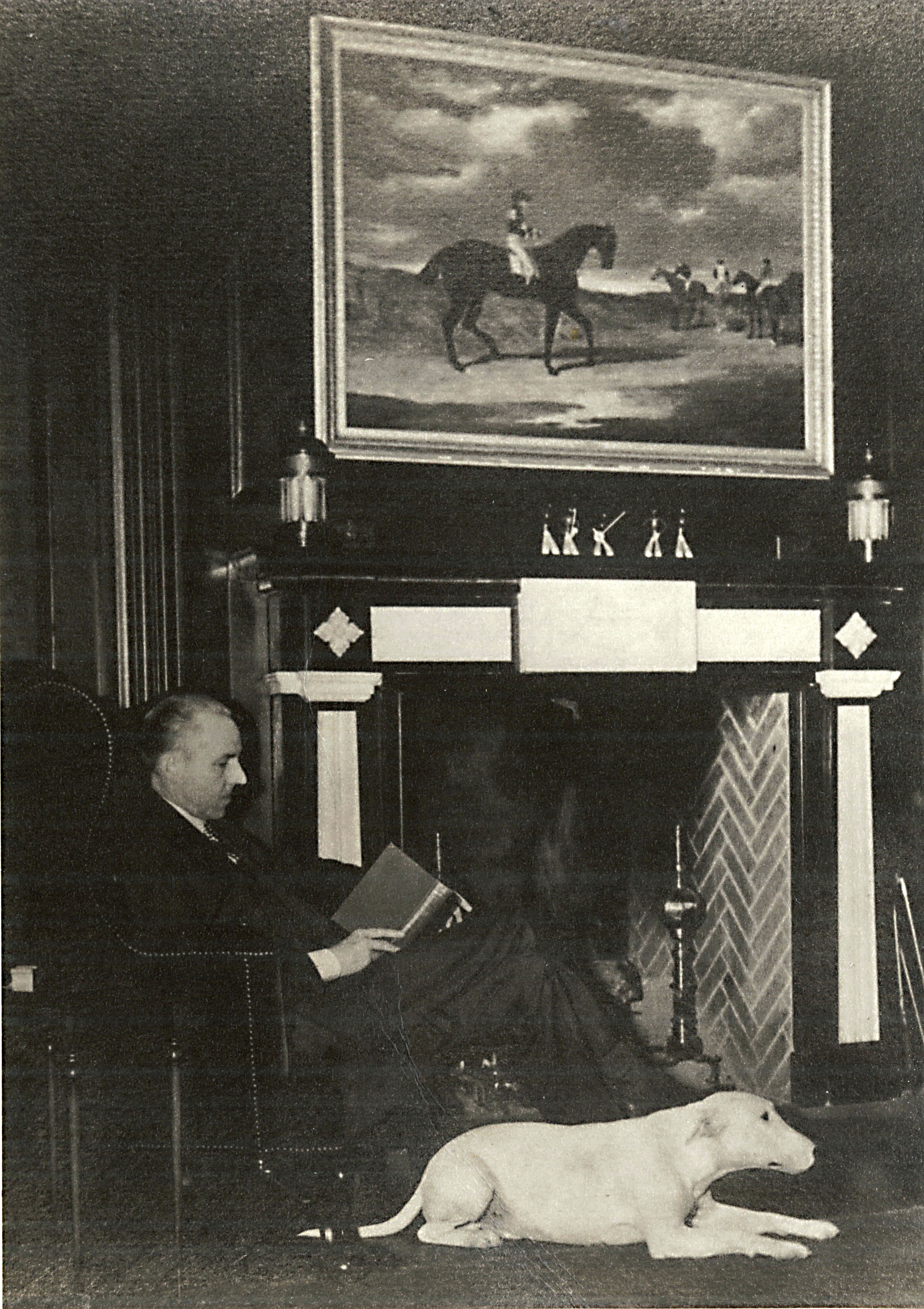a man sitting in a chair reading a book