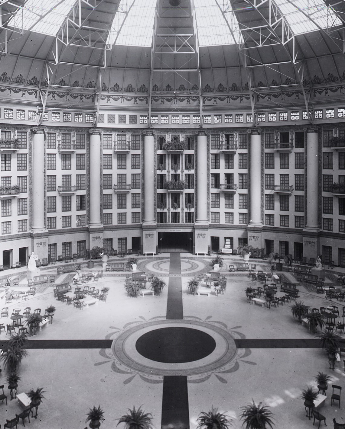 a large circular building with many columns and tables