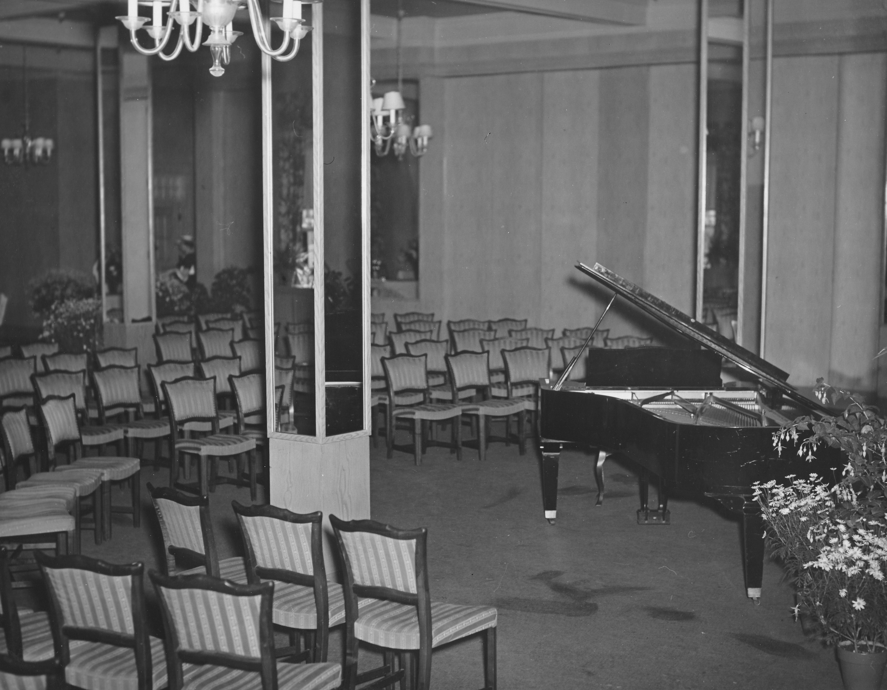a piano in a room with chairs