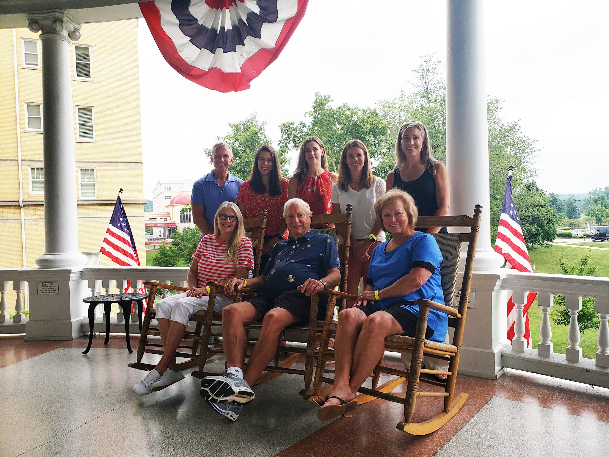A group of people on a hotel porch
