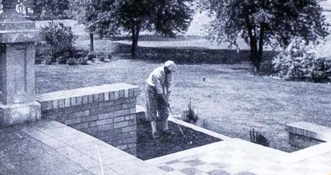 a man playing golf in a yard